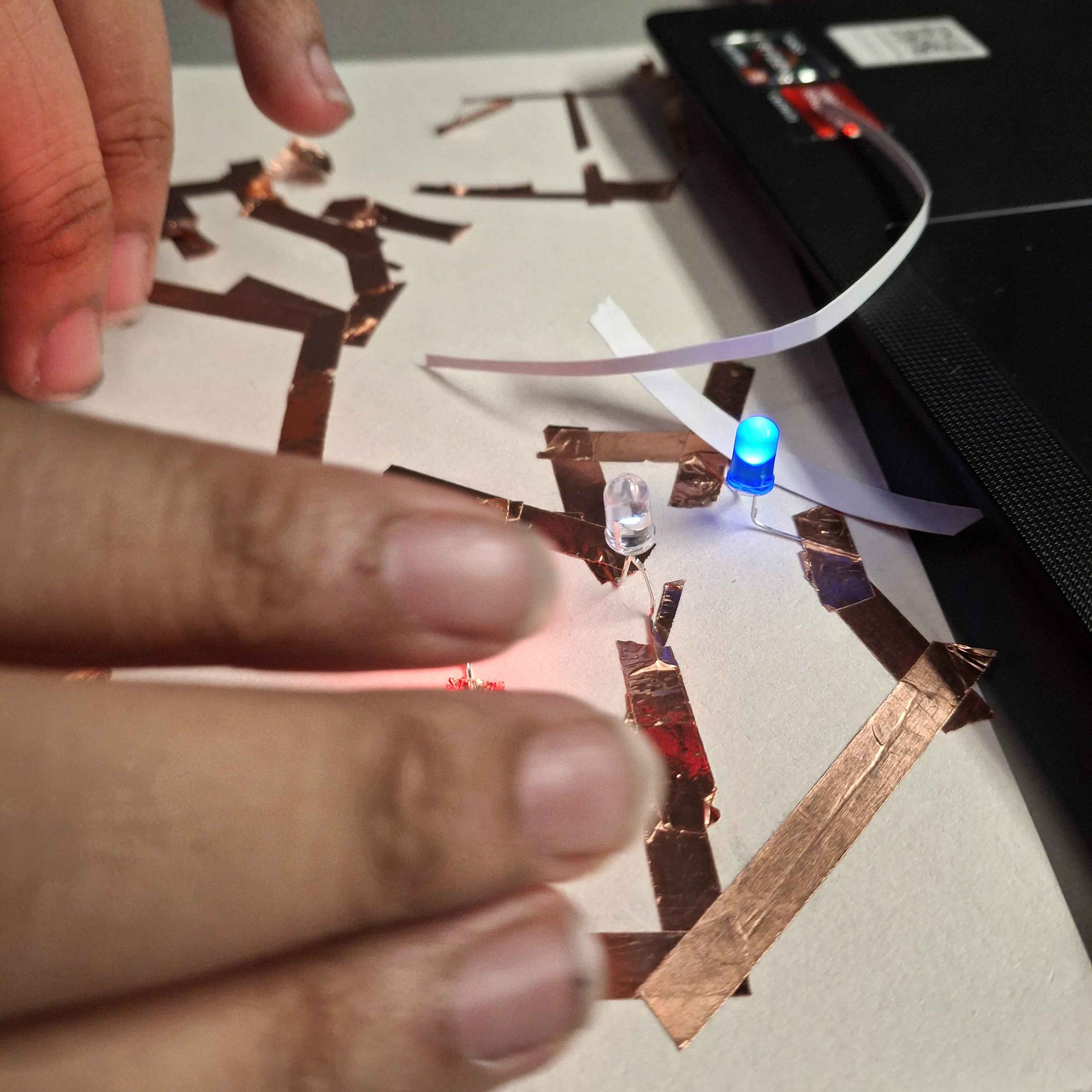 I wanted to experiment with parallel circuts and was intrigued by wiring and how it felt like a puzzle to me. My initial circuts were very messy and a lot of trial an error in terms of tape placement. 